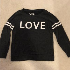 dark grey crew neck with “love” on the front
